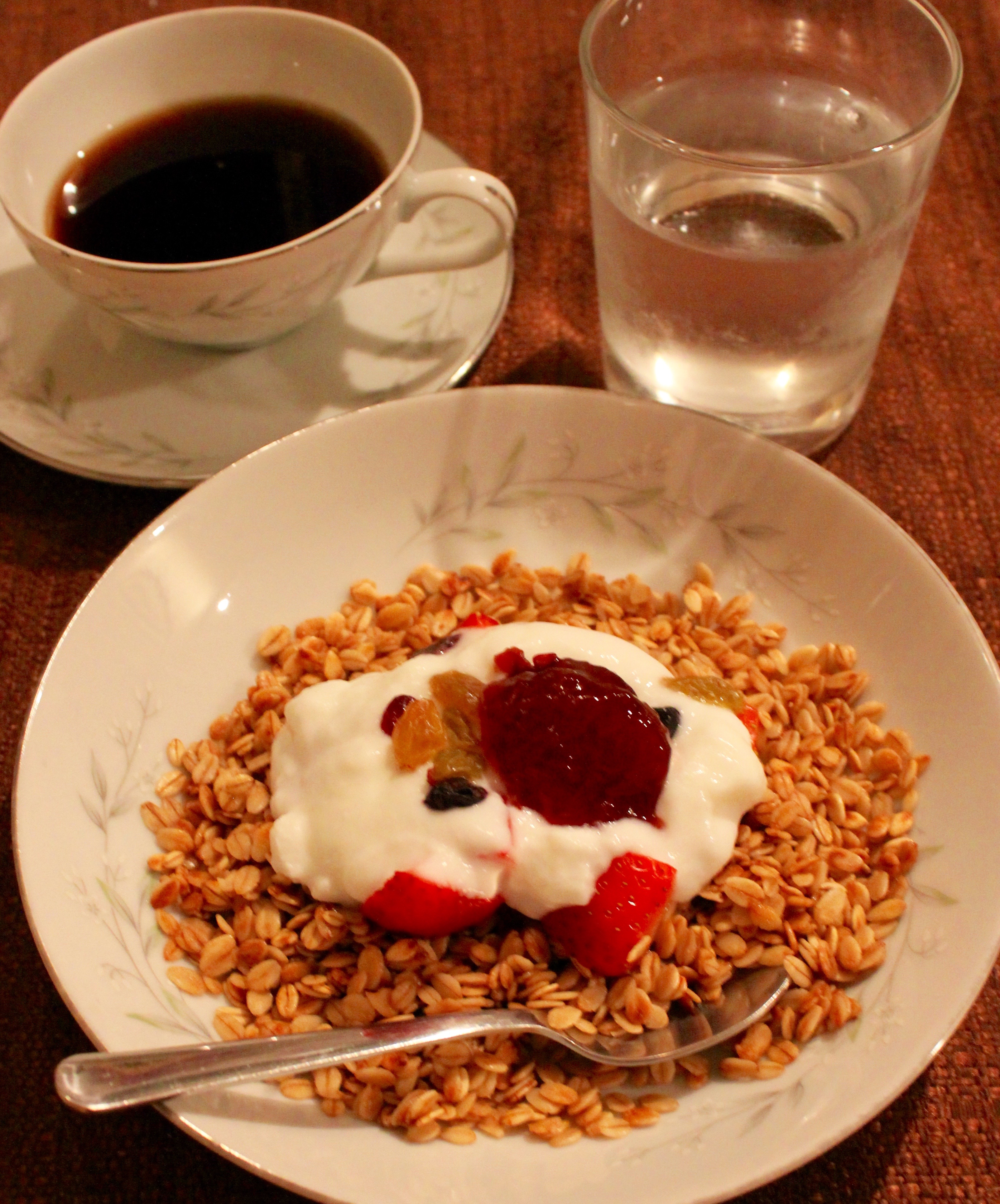 Certified Gluten Free granola with goat yoghurt, dried fruit, fresh strawberries, and a dollop of jam. 