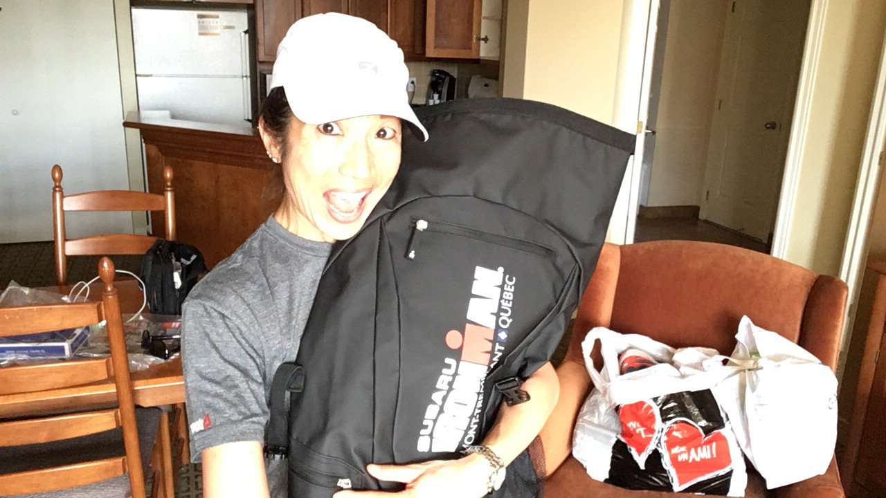 Author holding large black Ironman bag against her chest while smiling.